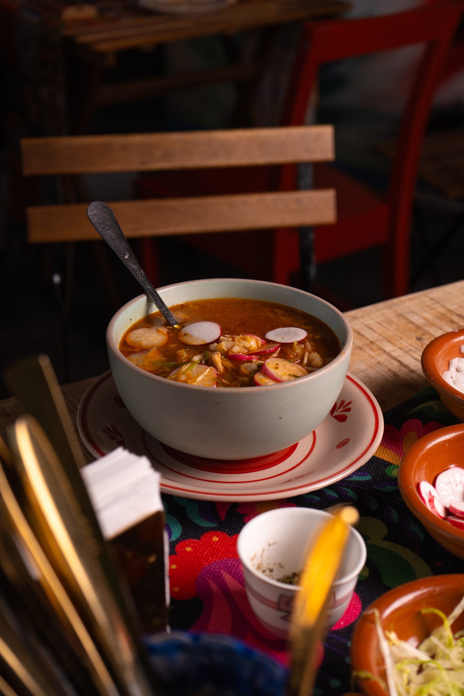 Querida Magazine — Mama's Best · Pozole rojo y blanco, page 2 of 10. Ten plates from Mama's kitchen — the new pozole, the family table, the room when it fills. Destination: Querida — Al Barsha 1, Dubai.