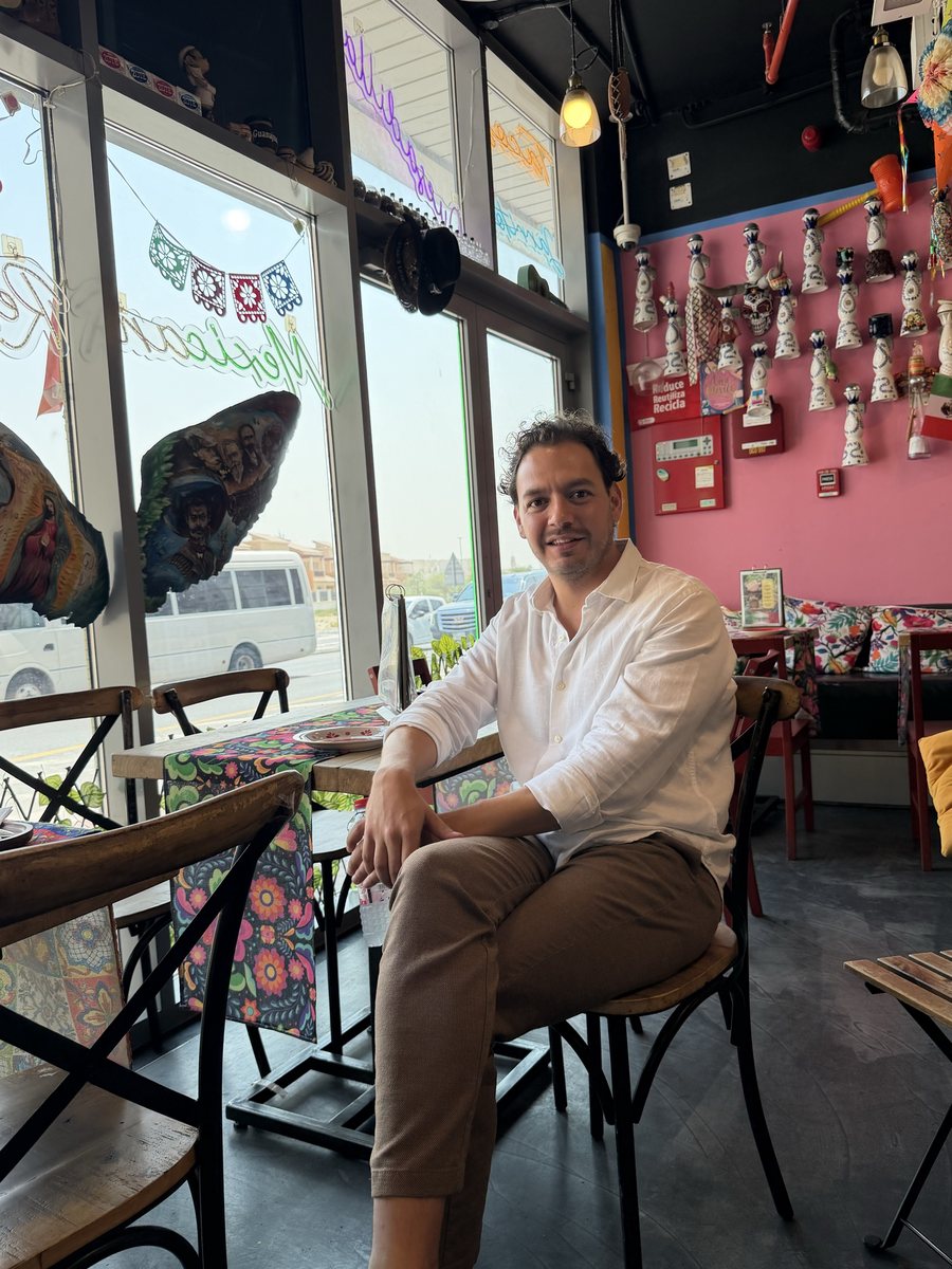 Alan of CLOC Food, seated in Querida's pink dining room in Al Barsha 1