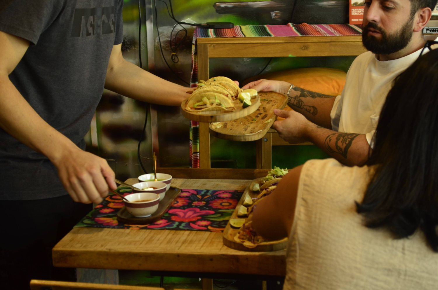 Tacos handed across the table at Querida