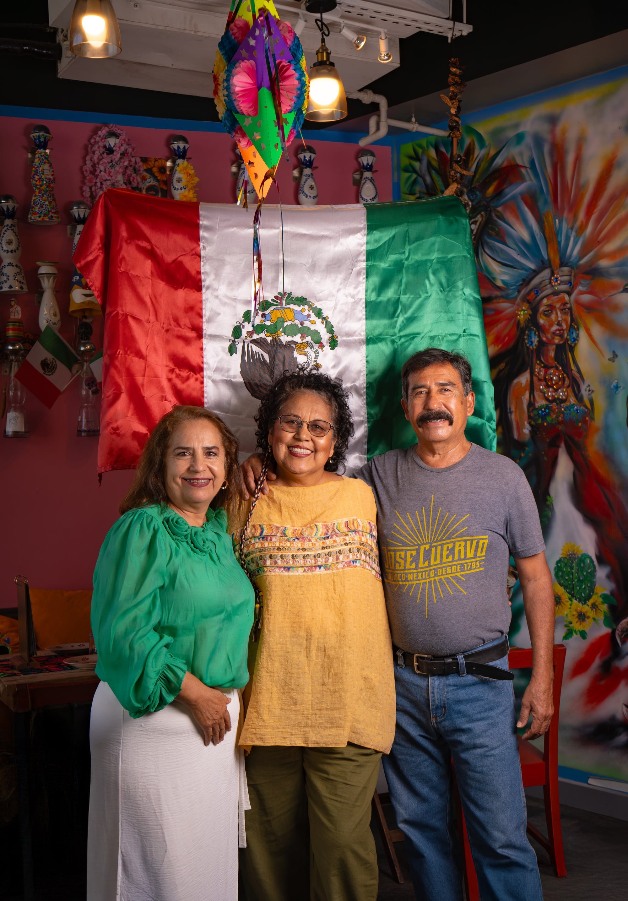 Mama Lalis with the founders' families in front of the Mexican flag
